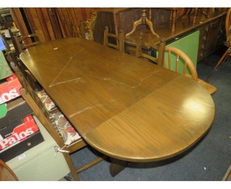 AN OAK ERCOL STYLE DROPLEAF DINING TABLE WITH SIX CHAIRS