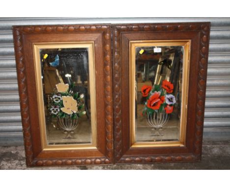 A PAIR OF VINTAGE OAK FRAMED FLORAL MIRRORS (ONE A/F) 82 CM BY 52 CM