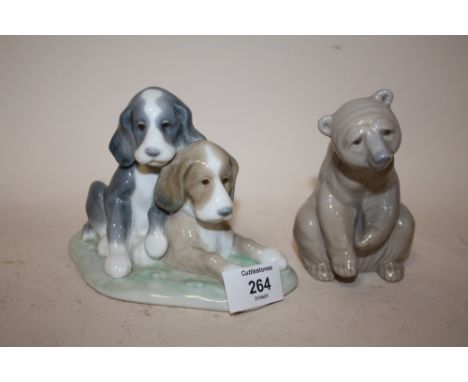 A LLADRO FIGURE OF A SEATED BROWN BEAR TOGETHER WITH A NAO FIGURE OF PUPPIES