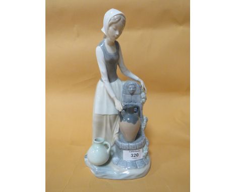 A NAO FIGURE OF A LADY BESIDE A FOUNTAIN