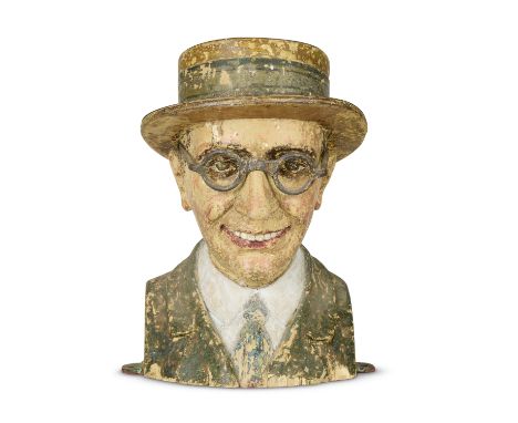 A French carved and painted spinner game in the form of a bust of Harold LloydAttributed to Henri De Vos, circa 1920sThe boat