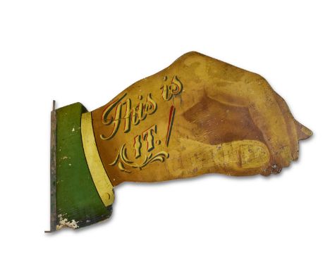 An Edwardian painted fret carved ticket signPainted on each side, in the form of a hand, with the words 'This Is It', 98cm wi
