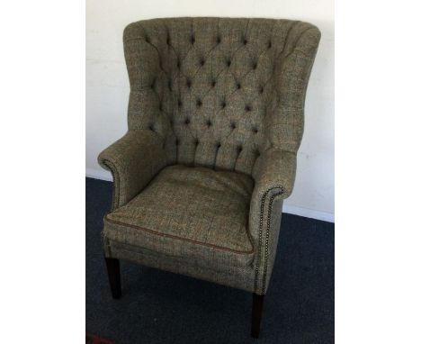 A tall button back armchair.