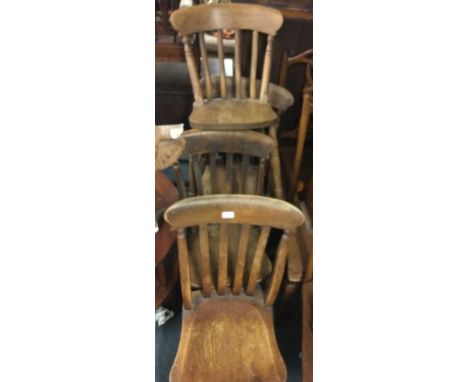 A set of four stick back chairs.
