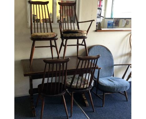 A good table with five chairs of Ercol design.