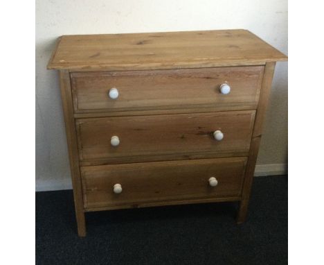 A stripped pine chest of drawers.