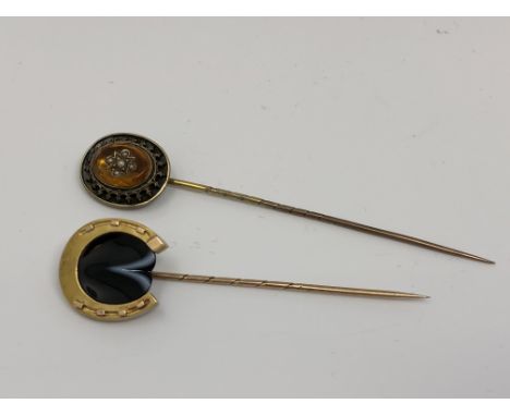 Two 15ct gold stick pins; one horseshoe shaped and set with agate and the other set with citrine and pearls (2)