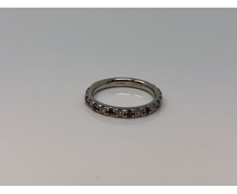 A platinum ruby and diamond half eternity ring, size I (two rubies missing) CONDITION REPORT: 3.5g