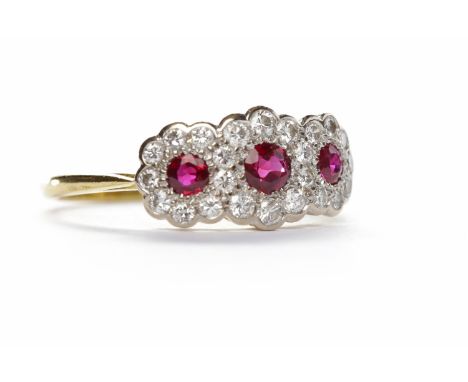 RUBY AND DIAMOND CLUSTER RINGset in eighteen carat gold, with three round brilliant cut rubies surrounded by round brilliant 