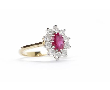 RUBY AND DIAMOND CLUSTER RINGset with an oval cut ruby surrounded by ten round brilliant cut diamonds, in eighteen carat gold