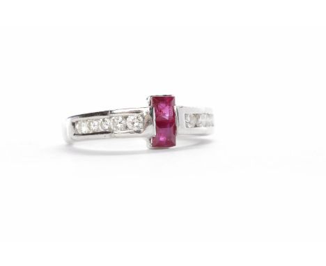 RUBY AND DIAMOND DRESS RINGset centrally with two princess cut rubies, with five channel set round brilliant cut diamonds to 