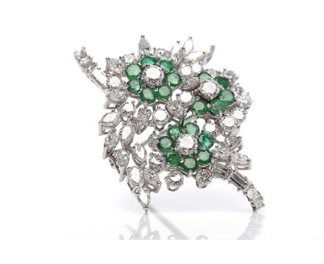 IMPRESSIVE ART DECO DIAMOND AND EMERALD DRESS CLIPformed by three principal floral clusters, each cluster with a central bril