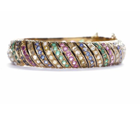 GEM SET BANGLEset with approximately 244 stones including sapphire, ruby, emerald, diamond and pearl, unmarked