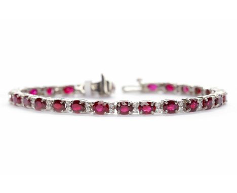 EIGHTEEN CARAT WHITE GOLD RUBY AND DIAMOND TENNIS BRACELET set with twenty six oval rubies with an approximate total carat we