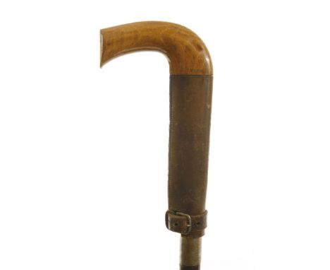 A 'Cowens Patent' cane,concealing a lopper behind a leather collar that holds the handle and the rustic shaft together, 98.8c