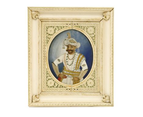 An Indian ivory portrait of a maharaja,three-quarter length watercolour on ivory, 12 x 14.5cm, in a carved ivory and tinted f