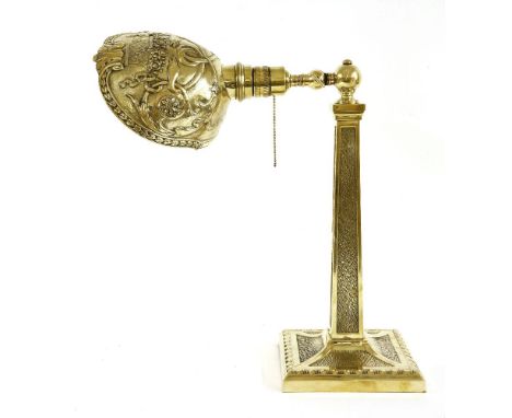 A Victorian polished brass table lamp,the panelled column with 'fur' panels, the cast shade stamped 'Perry 4890 B', 42cm high