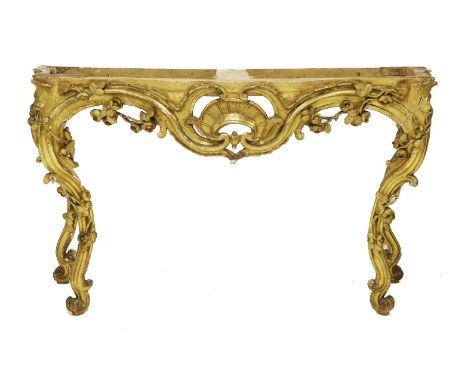 A French giltwood console table,18th century, the shaped front and scrolling legs with open carved trailing roses, terminatin