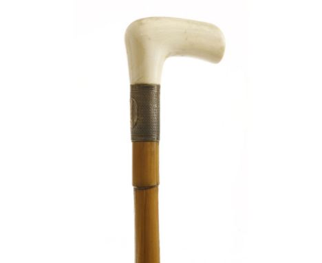 An ivory-handled cane,with a silver ferrule, the handle unscrews to reveal a corkscrew, 13cm long, inscribed 'T Barraclough L