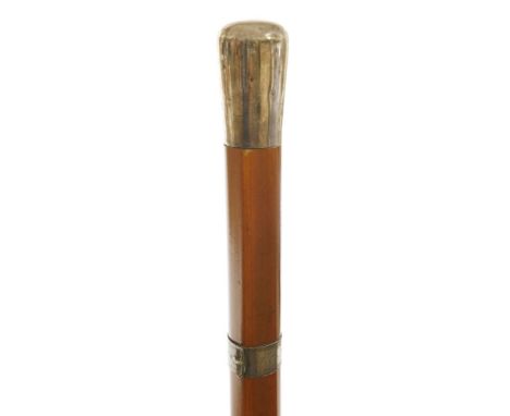 A malacca-shafted cane,c.1910, with a buckle collar and a white metal handle, concealing a corkscrew,92cm long