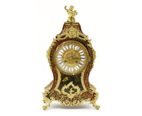 A boullework mantel clock,late 19th century, the cast foliate dial with applied enamel Roman numerals on a white ground, with