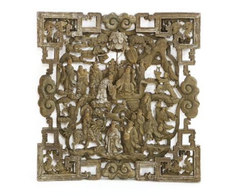 A Chinese wooden panel, pierced and carved with immortals and scholars within a landscape,77cm wide79cm high