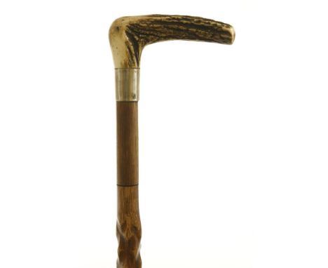 An oak 'barley corn' carved walking stick,with a bone hammer handle, a steel rapier concealed in the shaft,91.4cm long