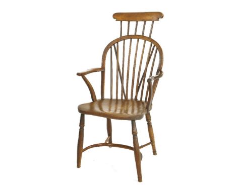 An elm and yew wood Windsor chair,19th century, with hooped stick back and headrest, above a solid seat on turned supports, u
