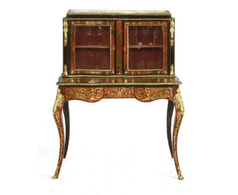 An ebonised and boullework bonheur du jourlate19th century, the three-quarter gallery over a serpentine glazed cabinet, with 