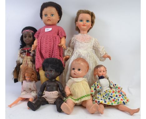 DOLLS: A collection of 7x assorted vintage dolls to include one stamped BND England, plastic dolls, vinyl dolls and others. M
