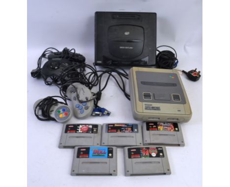 GAMING CONSOLES; Two original vintage computer game consoles; Super Nintendo Entertainment System SNES complete with transfor