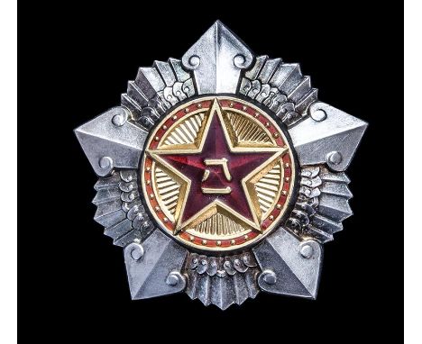 *China, People’s Republic, Order of August 1st, Third Class badge, in silver, with gilt and red enamelled centre, reverse num