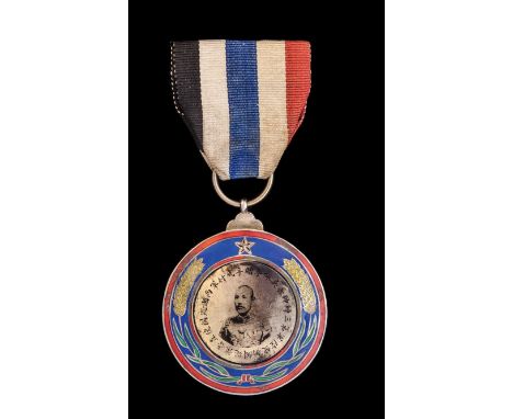 *China, Wei Pei Fu Merit Medal, circa 1925, in silver-gilt and enamels, with tin-type central portrait of the Marshal, width 