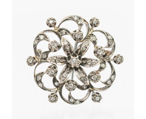 A diamond and gold floral brooch, comprising a circular flower motif grain set with small diamonds, width approx 30mm, silver