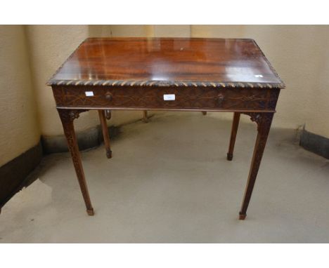 A 20th Century bottle green button back desk chair along with a reproduction Chippendale style mahogany desk with single draw