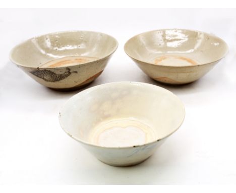 Two Chinese provincial possibly Swatow large glazed earthenware bowls, one plain, one decorated with two fish, along with an 