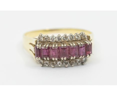 A ruby and diamond set 14ct gold ring, comprising a row of channel set calibre cut rubies within a border of claw set diamond