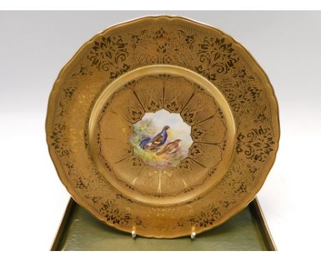 A Royal Worcester early to mid 20th Century plate , decorated with Black Grouse in a centre panel bordered by ornate gilding 