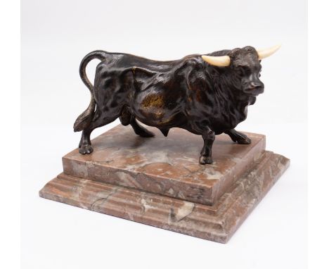 A patinated bronze figure of a bull with horns on mottled marble plinth base signed to the body Elwell. Height approx 12cm wi