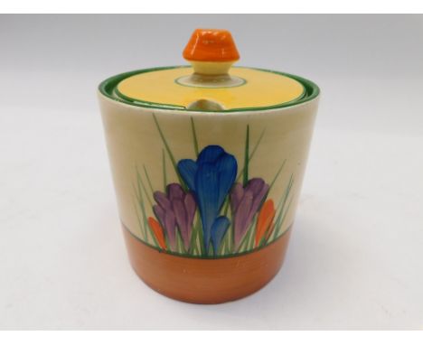 Clarice Cliff - a Crocus patterned preserve jar and cover, black facsimile stamp to base.  Condition: small old chip to under