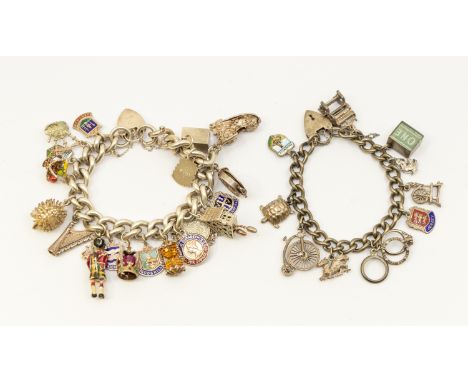 Two silver charm bracelets, including a heavy weight version, width approx 10mm, both with padlock clasps, suspending various