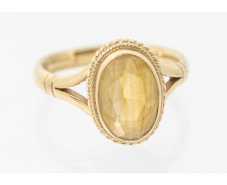 A citrine and 9ct gold ring, comprising an oval mixed cut, rope edge border, approx 13mm, split shoulders, size Q1/2, total g
