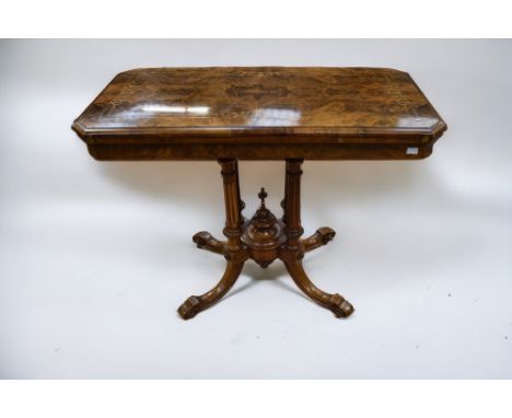 A mid 19th Century walnut and mahogany card/games table with folding and twist top playing surface, ornate supports on four s