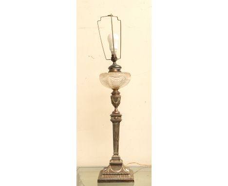 A late 19th Century silver plated columned oil lamp with ribbed and swag design, with cut glass central area, converted to a 