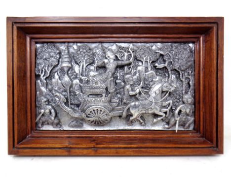 A decorative silvered Thai plaque in wooden frame 