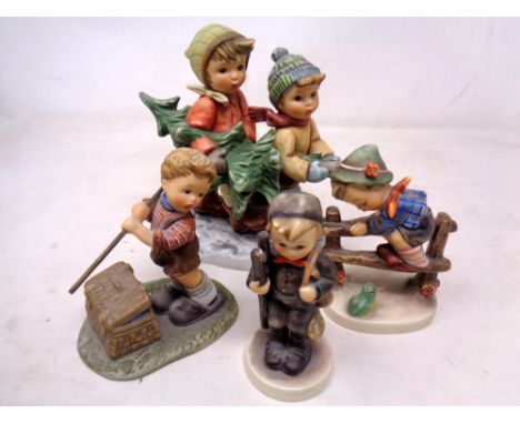 A Goebel figure group 'Tree Trimming Time' together with three further Goebel figures 