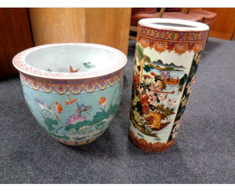 A Chinese style fishbowl planter decorated with herons together with a Japanese style stick pot decorated with geisha 