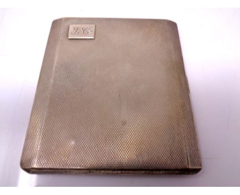 A silver cigarette case with engine turned decoration together with a silver heart shaped bookmark 