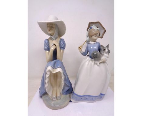 Two Nao figures of a girl with parasol and girl seated with bonnet 