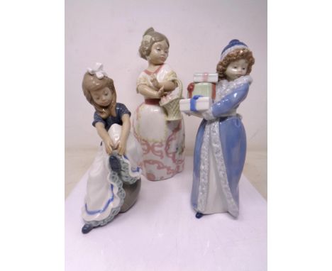 Three Nao figures of a girl with presents, girl in Spanish dress and seated child 